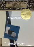 A kit that will teach you how to make three accordion books with a white, grey, and black cover.