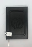 Black journal with a raised design on the cover. 