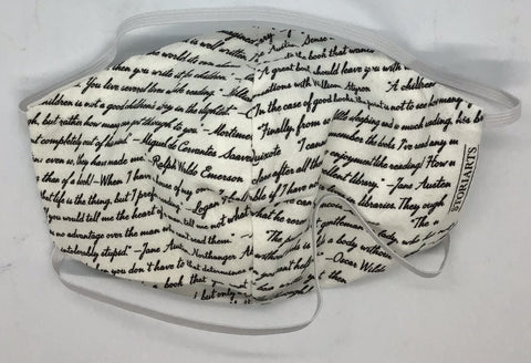 Off white mask with black hand writing across all of the fabric. 